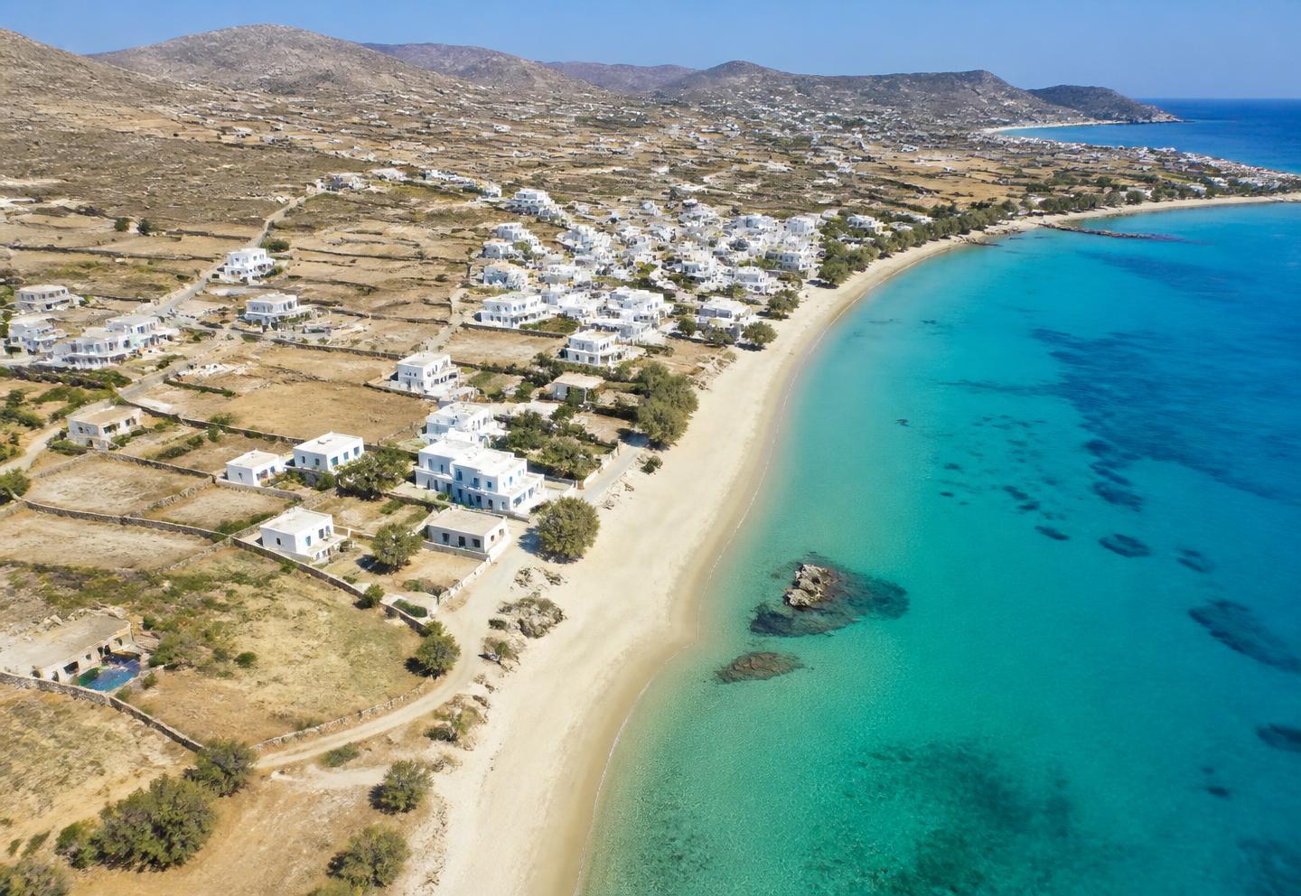 Aerial view of Kastraki village and the turquoise Aegean coast in Naxos, Greece